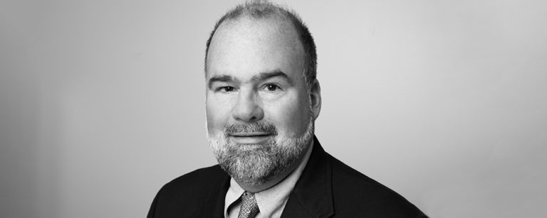 Black and white headshot of Jim Swanson
