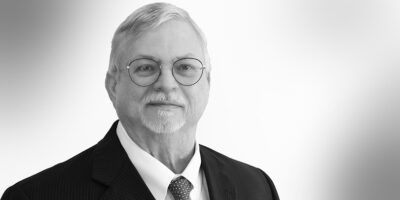 Black and white headshot of attorney Noel Darce