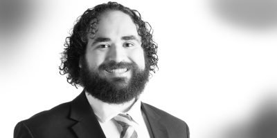 Black and white headshot of corporate attorney Teddy Todaro